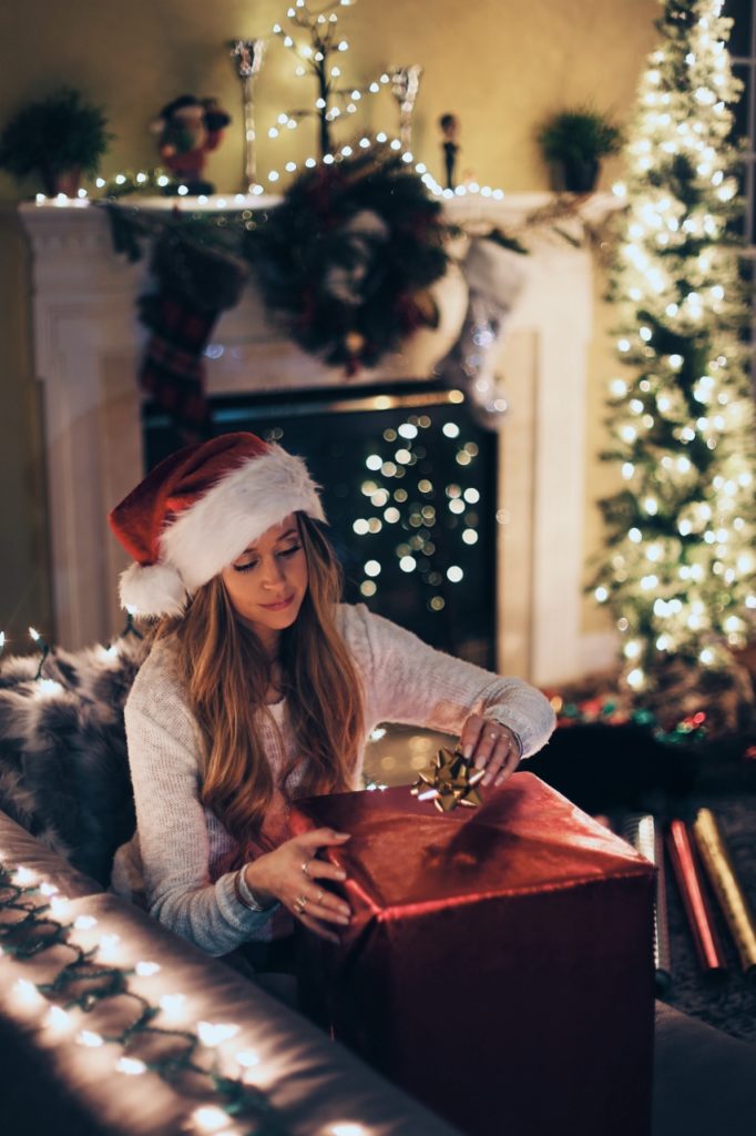 christmas-woman-opening-gift-853x1280