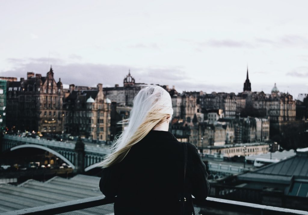 wind-woman-overlooking-city (1280x893)