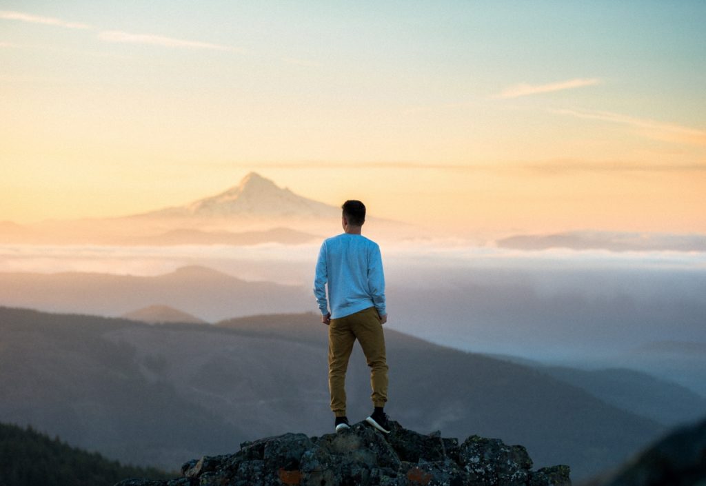 man-on-mountain-overlooking-mountains (1280x881)